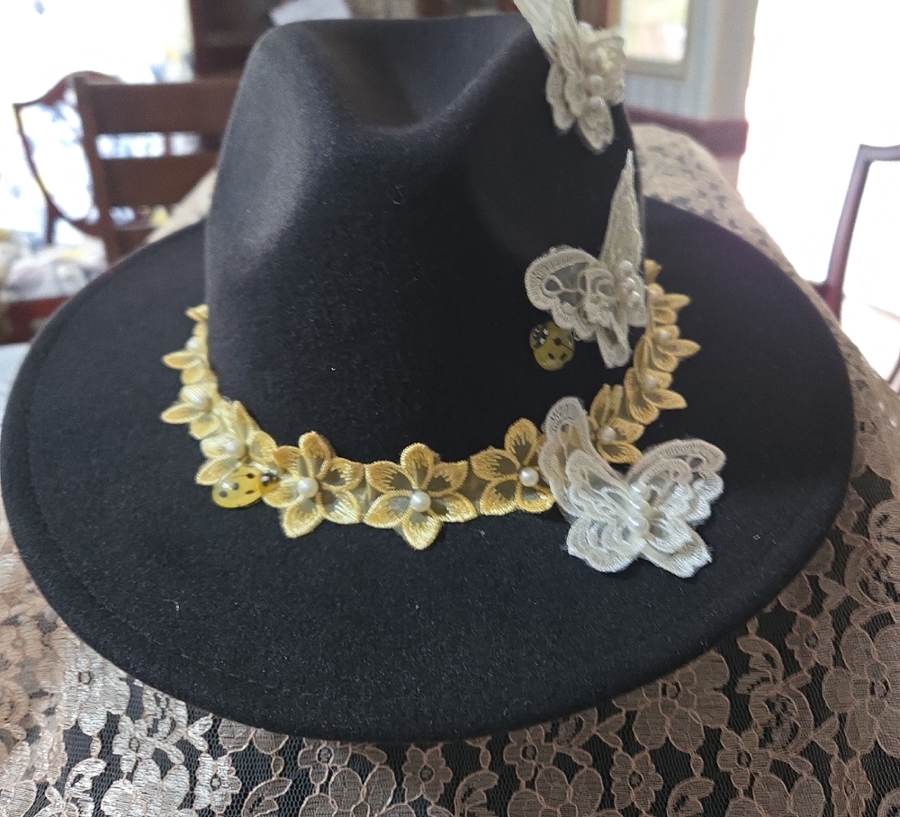 Elegant Black Hat with Gold and White Floral Accents